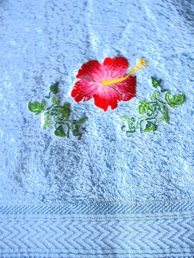 Handtuch♥in hellblau♥mit einer Hibiskusblüte♥und einer Blätterranke♥bestickt♥ von Hobbyhaus