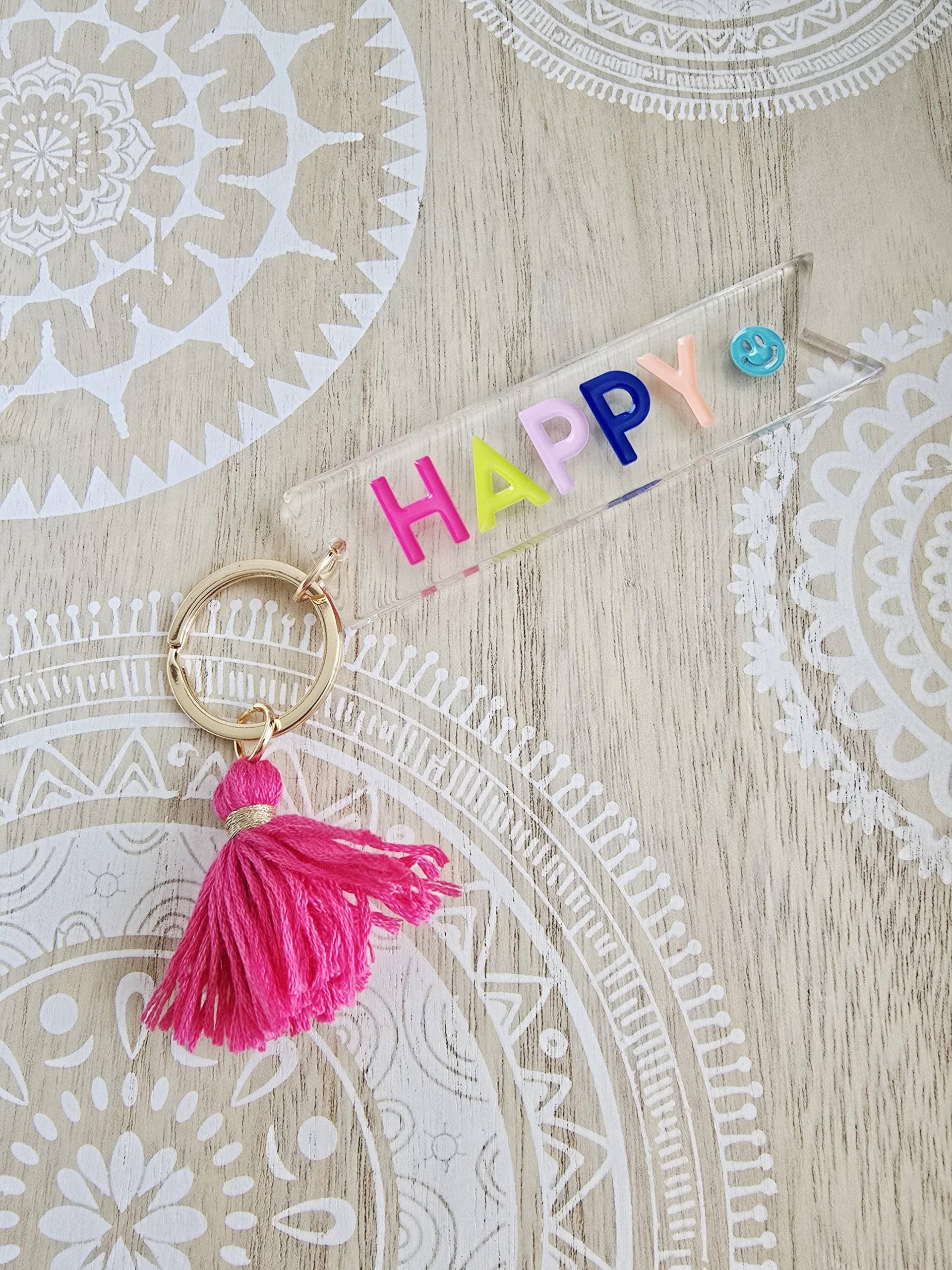 Happy Schlüsselanhänger Transparent Mit Quaste Pink Gold Happy Schlüsselanhänger Transparent Mit Quaste Pink Gold von 1000Gluecksmomente