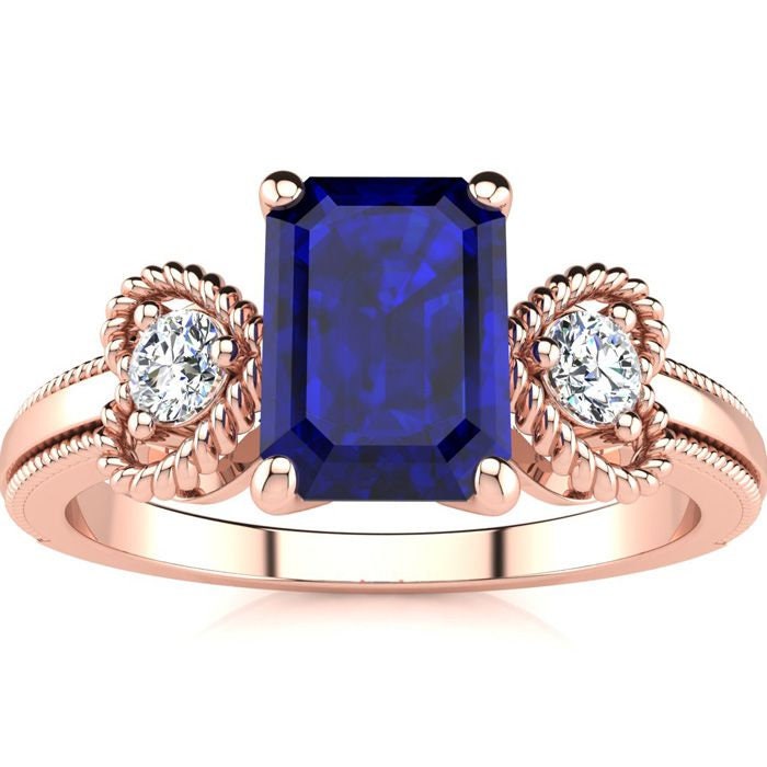 10 Karat Rose Gold 1 1/4 Smaragdschliff Saphir Und Zwei Diamant Herz Ring 10 Karat Rose Gold 1 1/4 Smaragdschliff Saphir Und Zwei Diamant Herz Ring von 47thStreetJewelry