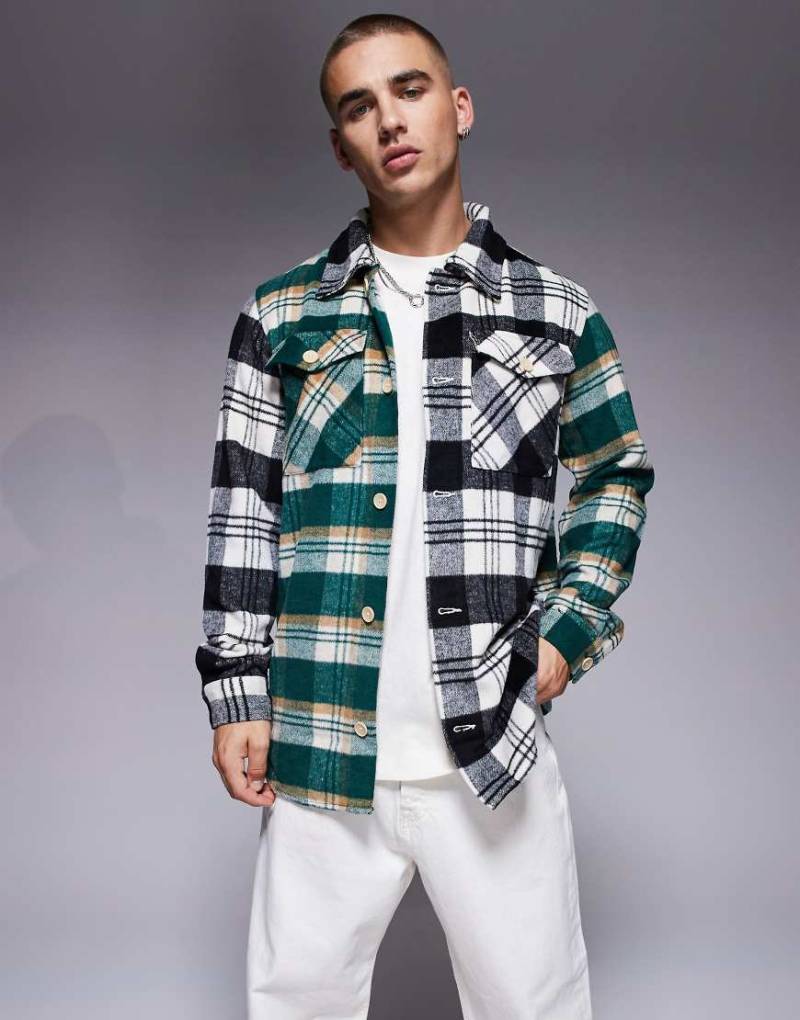 ADPT - Stark angeraute Oversize-Hemdjacke mit Karomuster in Schwarz und Grün-Neutral von ADPT