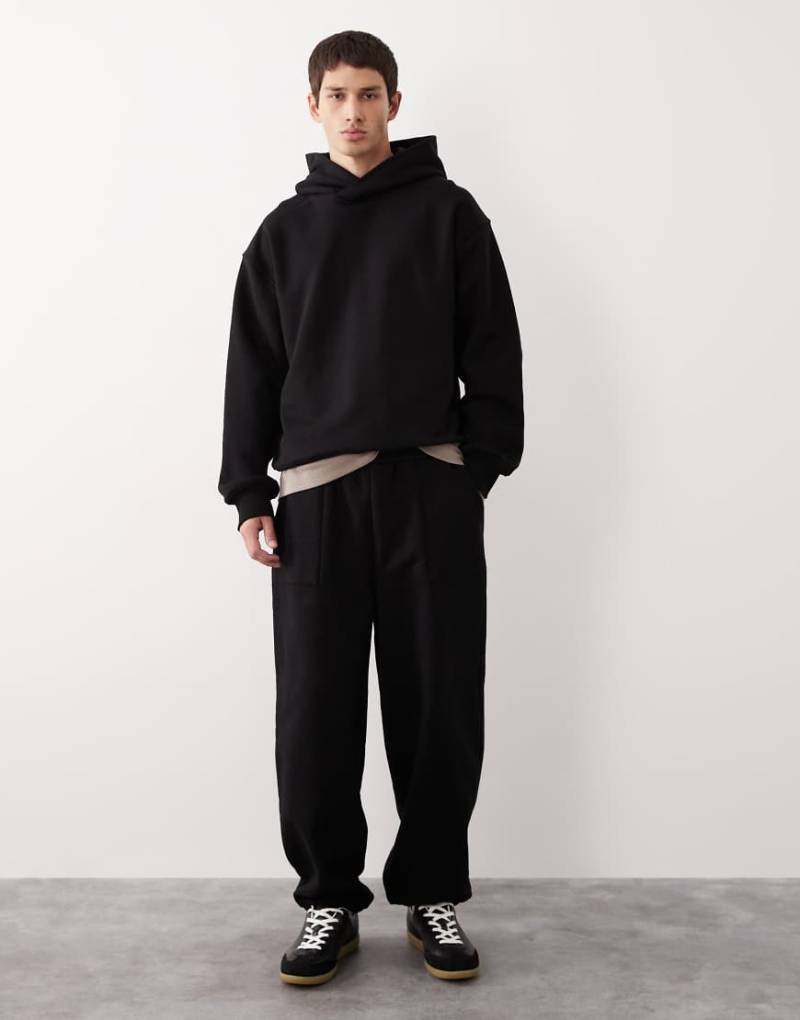 ASOS COLLECTIVE - AC-B-2571 - Jogginghose aus schwerem Stoff in Schwarz mit Bündchen und Signatur ASOS COLLECTIVE - AC-B-2571 - Jogginghose aus schwerem Stoff in Schwarz mit Bündchen und Signatur von ASOS COLLECTIVE