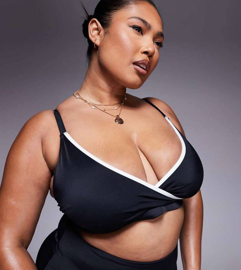 ASOS DESIGN Curve - Exklusives schmales kurzes Bikinioberteil in Schwarz mit Kontrasteinfassung von ASOS Curve