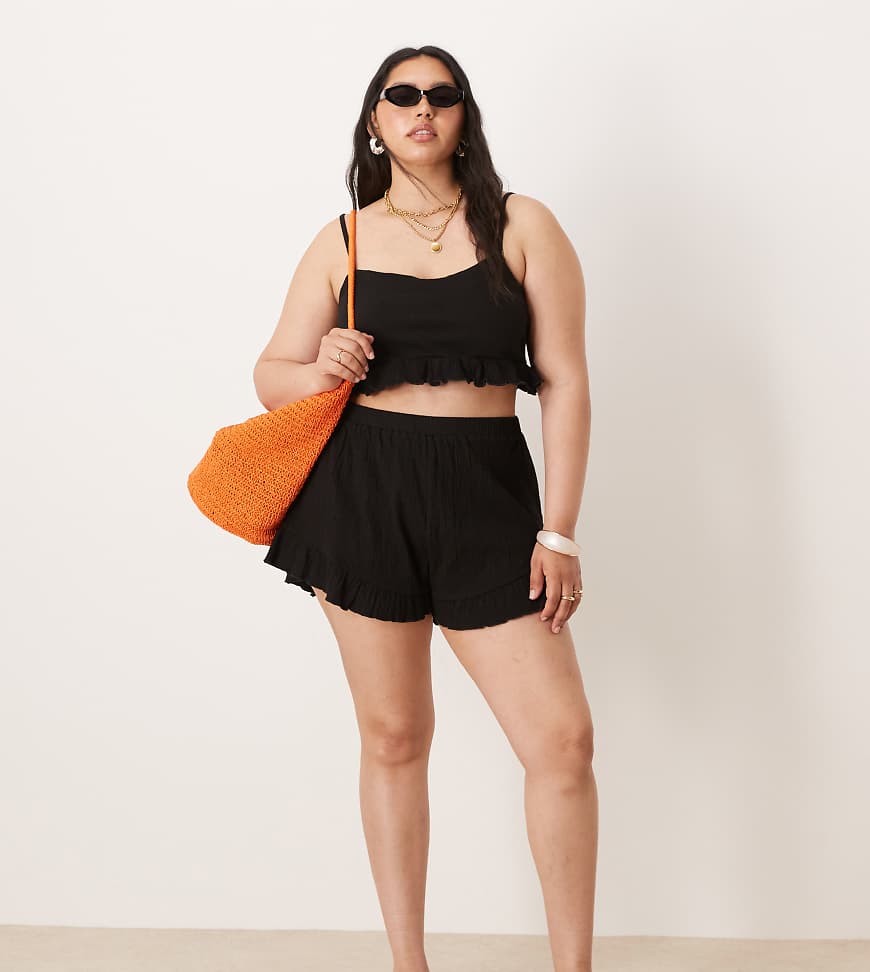 ASOS DESIGN Curve - Schwingende Shorts in Schwarz mit Knitteroptik, Kombiteil ASOS DESIGN Curve - Schwingende Shorts in Schwarz mit Knitteroptik, Kombiteil von ASOS Curve