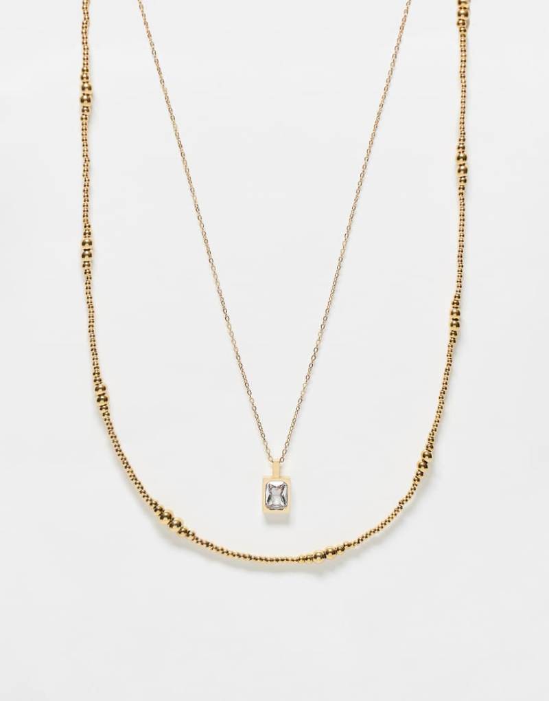 ASOS DESIGN - 2er-Pack goldfarbene Halsketten aus Edelstahl mit Perlen Kristall-Anhänger von ASOS DESIGN