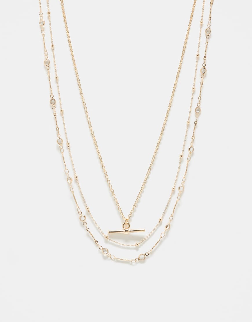 ASOS DESIGN- 3er-Pack Halsketten in Goldoptik mit T-Steg und Sternendetail-Goldfarben ASOS DESIGN- 3er-Pack Halsketten in Goldoptik mit T-Steg und Sternendetail-Goldfarben von ASOS DESIGN