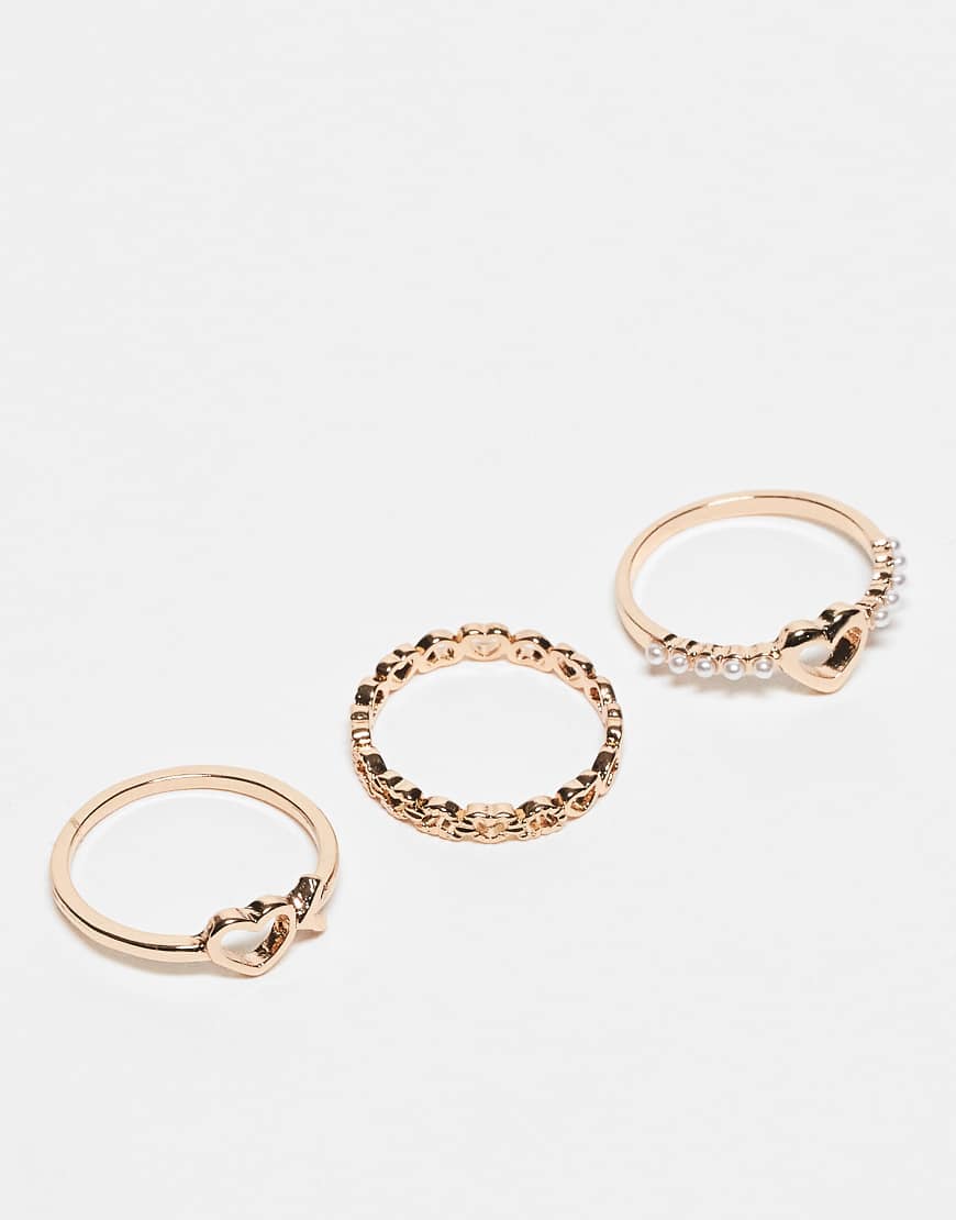 ASOS DESIGN - 3er-Pack goldfarbene Ringe mit Herz-Design von ASOS DESIGN