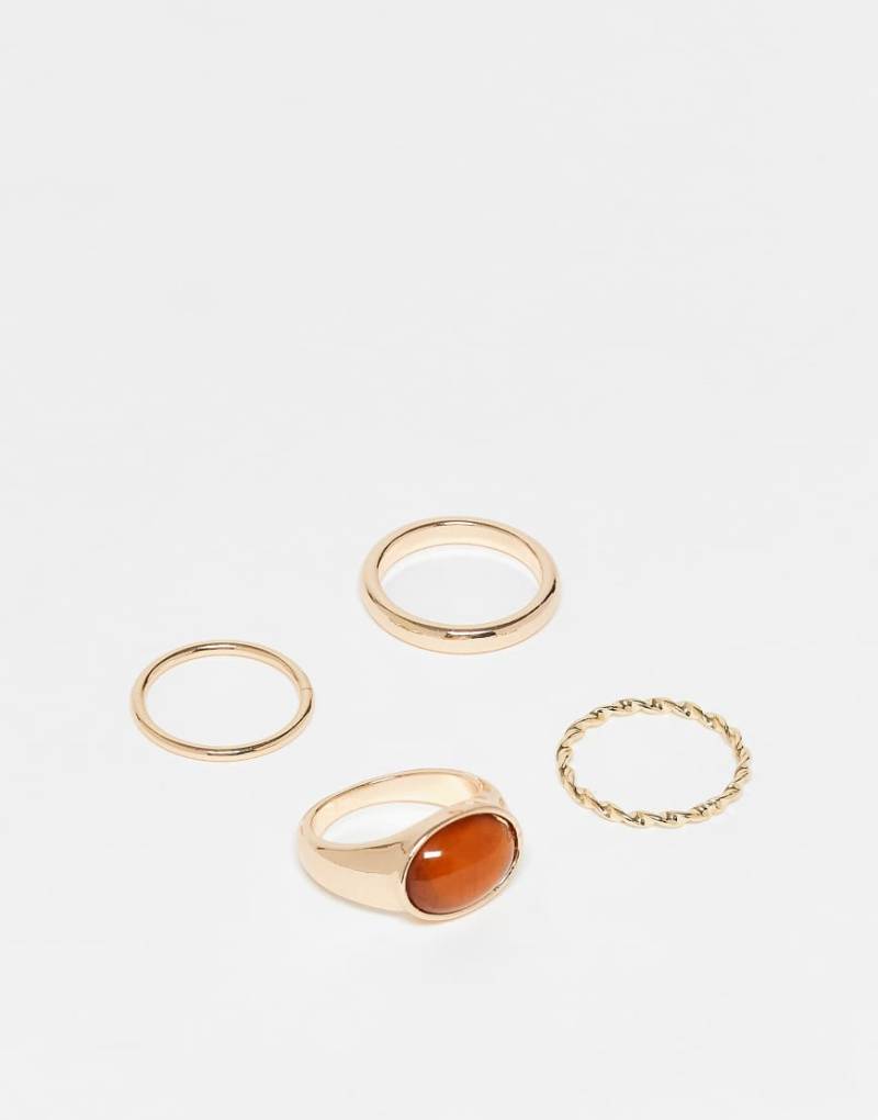 ASOS DESIGN - 4er-Pack goldfarbene Ringe mit verschiedenen Designs und Schmuckstein von ASOS DESIGN