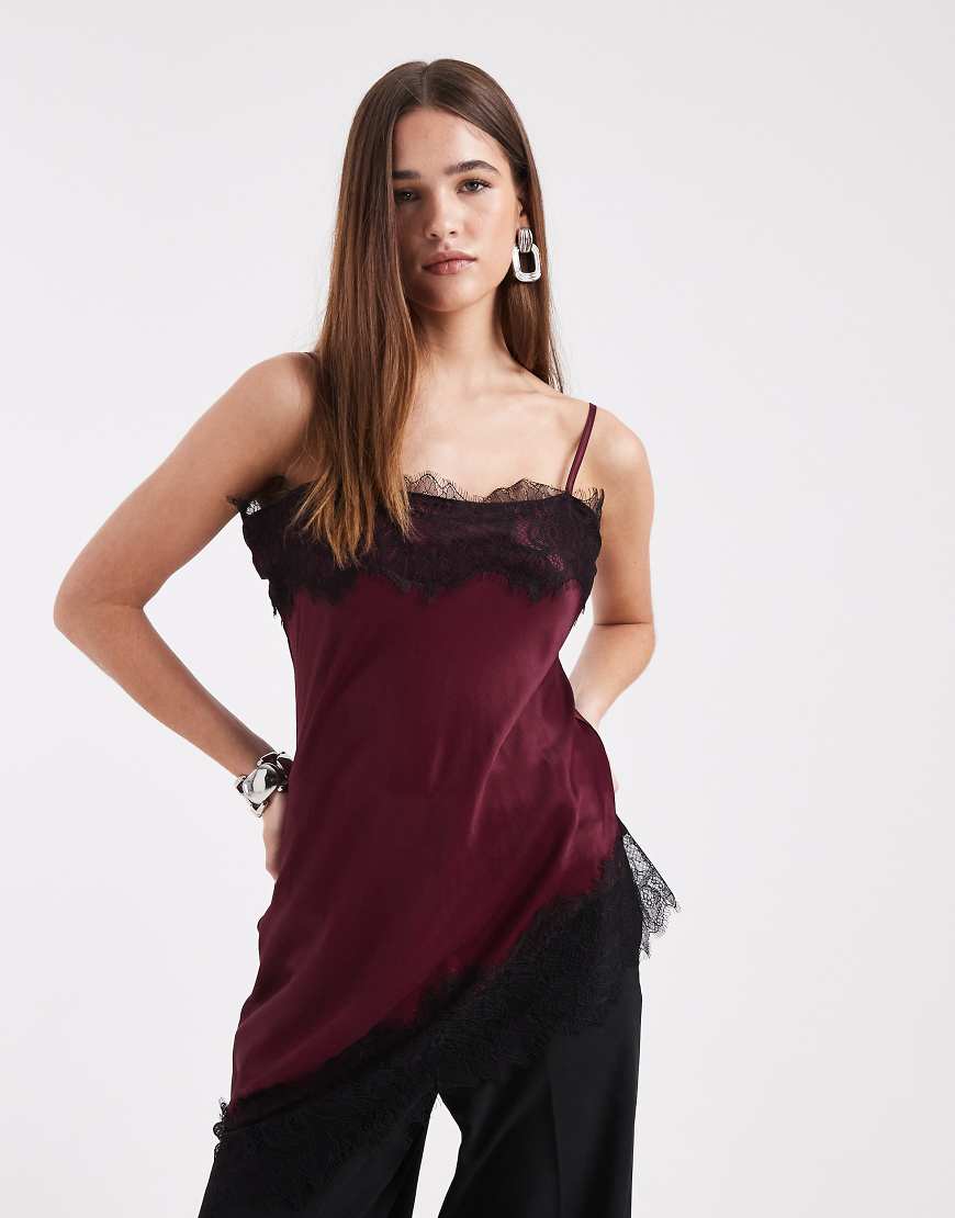 ASOS DESIGN - Camisole-Oberteil aus Satin in Pflaume mit asymmetrischem Saum und Spitzenbesatz-Lila von ASOS DESIGN