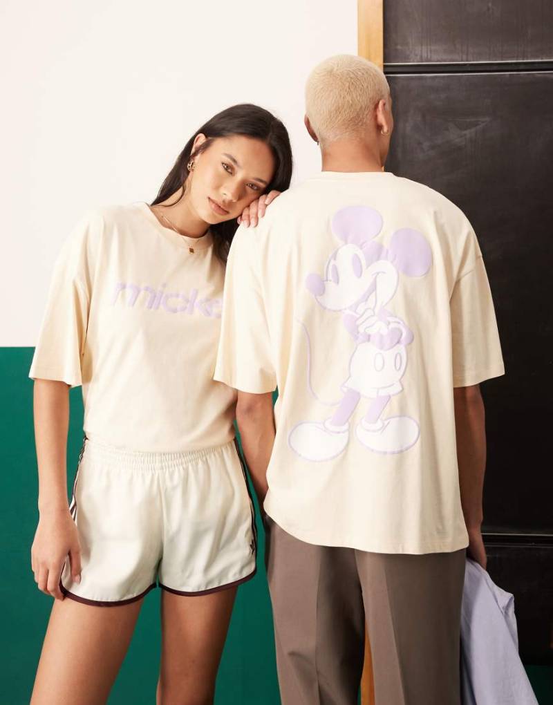 ASOS DESIGN - Disney - Unisex-T-Shirt in Buttermilchgelb mit Oversize-Passform und „Mickey Mouse"-Schaumprints-Neutral von ASOS DESIGN