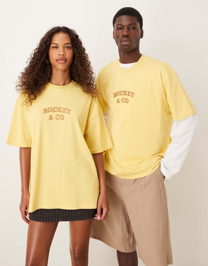 ASOS DESIGN - Disney - Unisex-T-Shirt in verwaschenem Gelb mit Oversize-Schnitt und „Mickey Mouse and Friends"-Westernprints von ASOS DESIGN