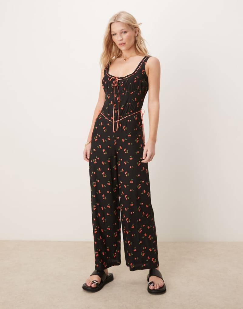 ASOS DESIGN - Durchgeknöpfter Jumpsuit aus gesponnenem Stoff in Schwarz mit Spitzenborte und Kirschmuster-Bunt von ASOS DESIGN