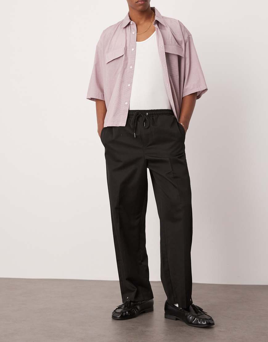 ASOS DESIGN - Elegante Hose zum Reinschlüpfen in Schwarz mit weitem Bein und Druckknopf von ASOS DESIGN