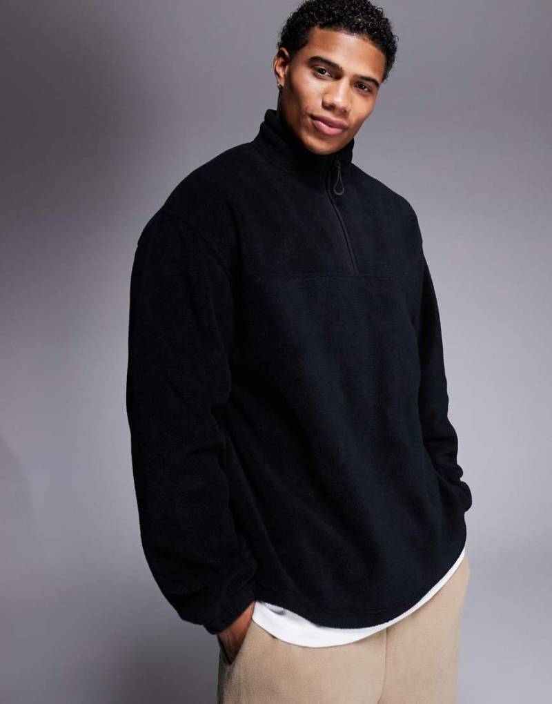 ASOS DESIGN - Fleece-Sweatshirt in Schwarz mit kurzem Reißverschluss und Oversize-Schnitt von ASOS DESIGN