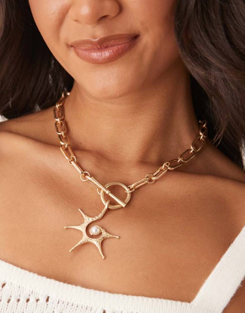 ASOS DESIGN - Goldfarbene Halskette mit stacheligem Sonnenanhänger und T-Steg-Detail von ASOS DESIGN