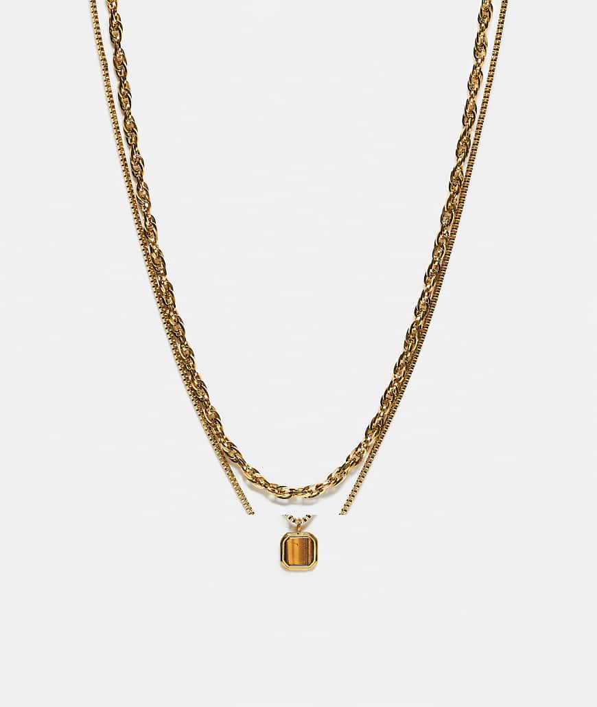 ASOS DESIGN - Goldfarbene Kordelkette aus wasserfestem Edelstahl im Zweierpack mit eckigem Anhänger mit Tigerauge-Halbedelstein von ASOS DESIGN