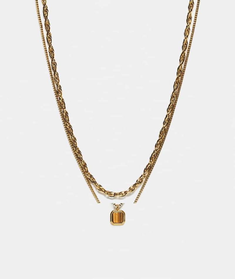 ASOS DESIGN - Goldfarbene Kordelkette aus wasserfestem Edelstahl im Zweierpack mit eckigem Anhänger mit Tigerauge-Halbedelstein von ASOS DESIGN