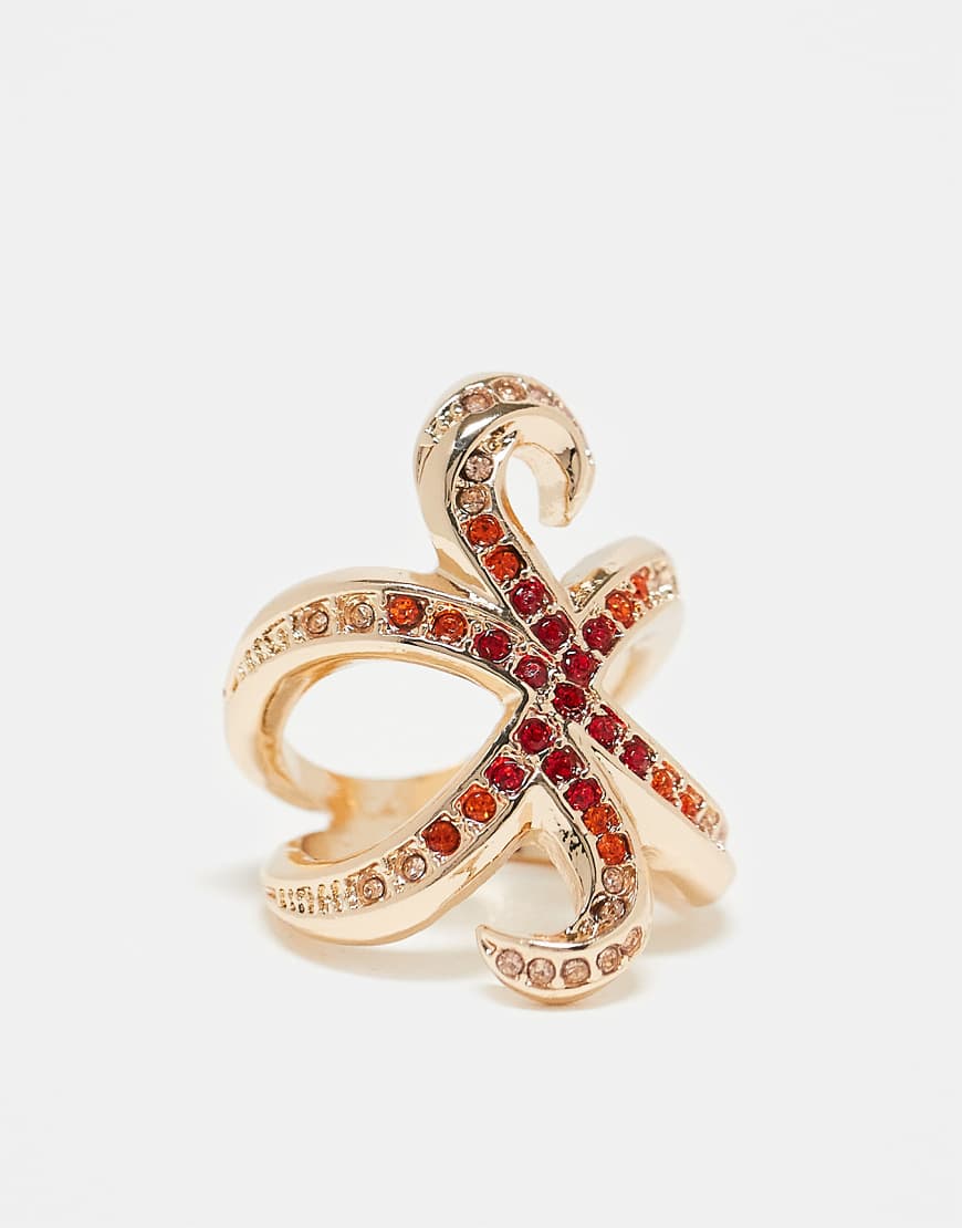 ASOS DESIGN - Goldfarbener Seestern-Ring mit roten Schmucksteinen von ASOS DESIGN