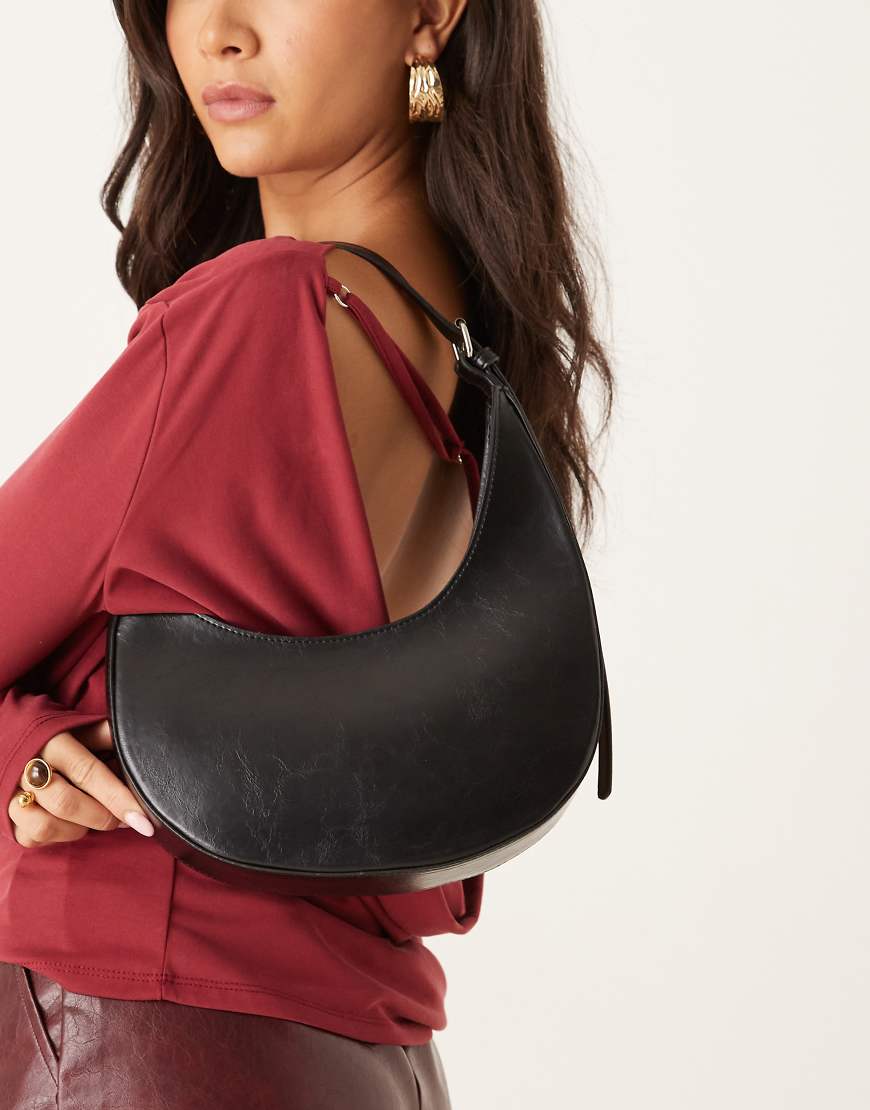 ASOS DESIGN - Halbmondförmige Schultertasche in Schwarz mit asymmetrischem Design und Schnallendetail ASOS DESIGN - Halbmondförmige Schultertasche in Schwarz mit asymmetrischem Design und Schnallendetail von ASOS DESIGN
