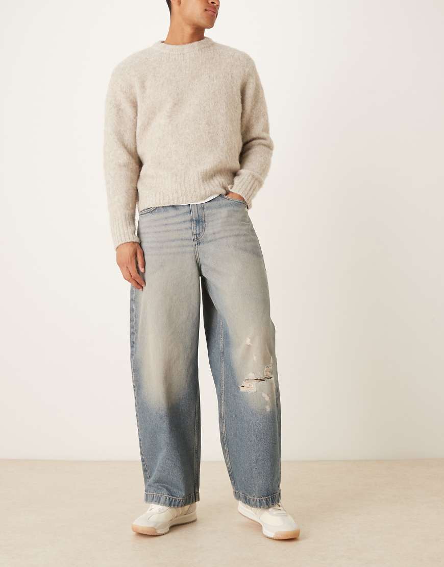 ASOS DESIGN - Jeans in hellblauer Waschung mit abgerundetem Beinschnitt, Farbstich und Zierrissen von ASOS DESIGN