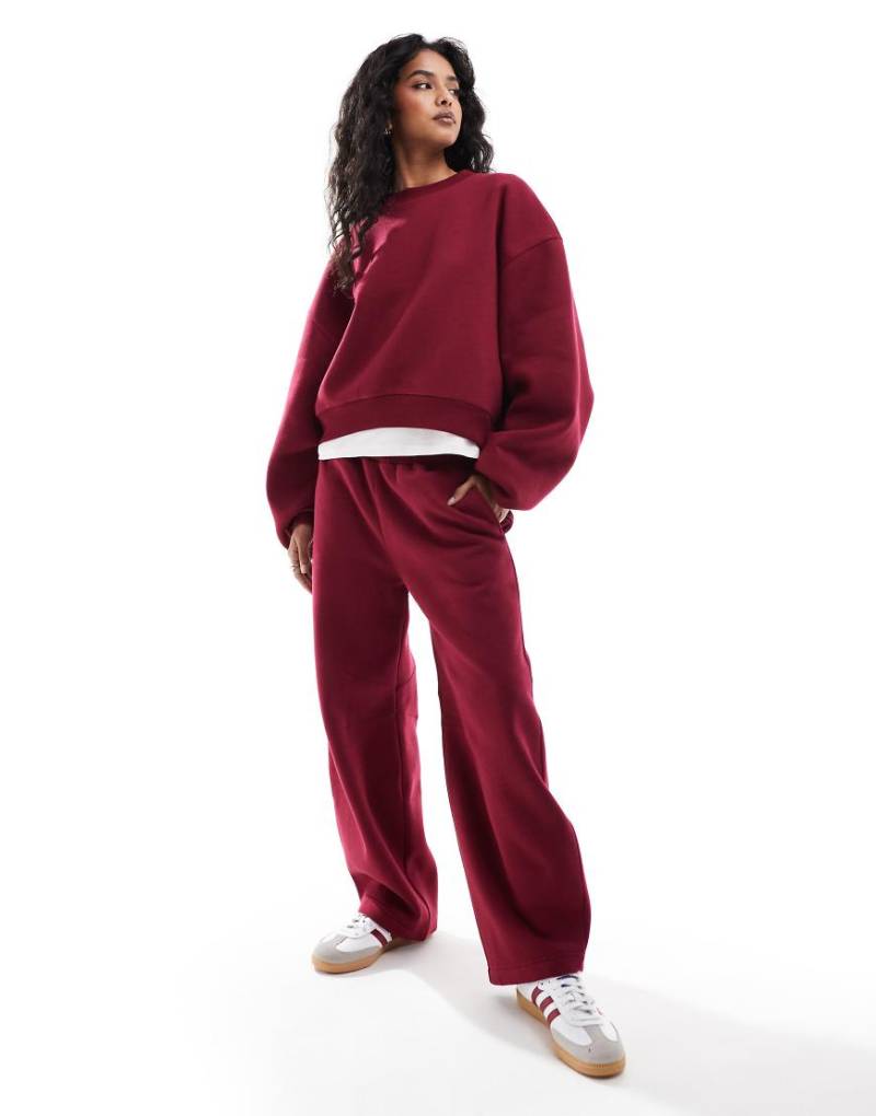 ASOS DESIGN - Jogginghose in Burgunderrot mit abgerundetem Beinschnitt von ASOS DESIGN