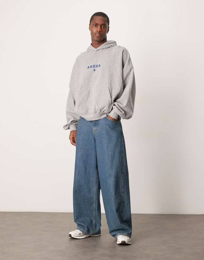 ASOS DESIGN - Kapuzenpullover in grau meliert mit Grafikprint im amerikanischen Stil und extremem Oversize-Schnitt von ASOS DESIGN