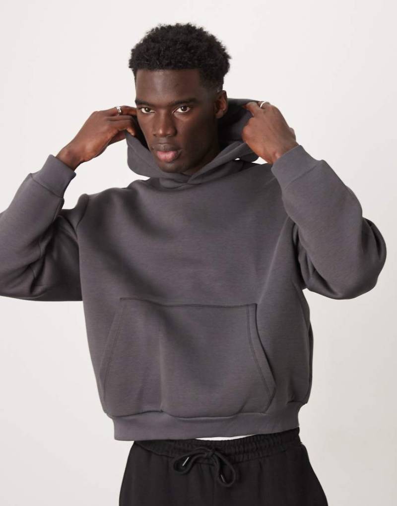 ASOS DESIGN - Schwerer, kastiger Oversize-Kapuzenpullover aus neoprenartigem Material in verwaschenem Schwarz-Grün von ASOS DESIGN