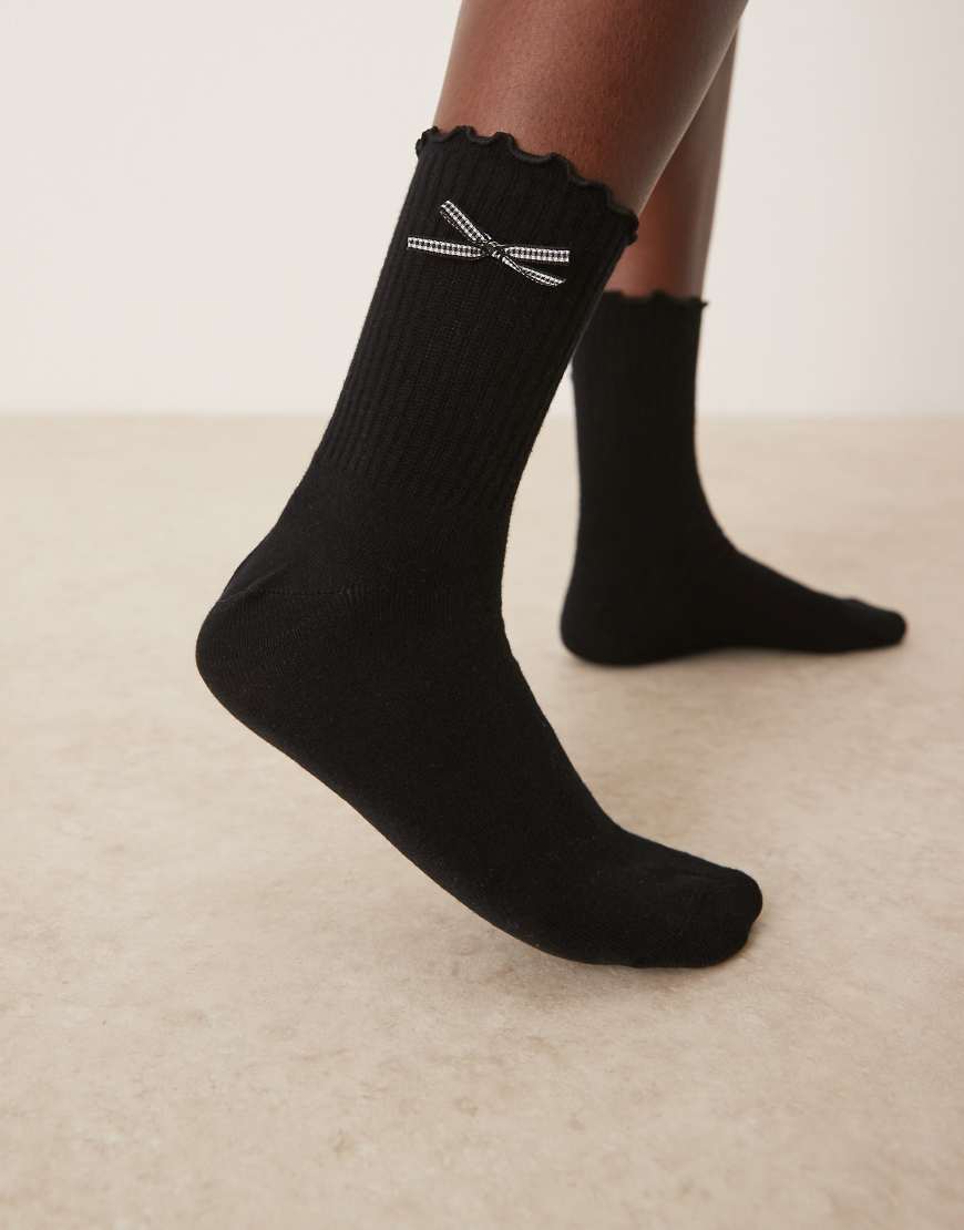 ASOS DESIGN - Knöchelsocken in Schwarz mit Schleife mit Vichy-Karos und Rüschen ASOS DESIGN - Knöchelsocken in Schwarz mit Schleife mit Vichy-Karos und Rüschen von ASOS DESIGN