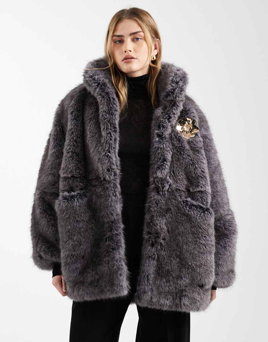 ASOS DESIGN - Kunstpelzjacke im 80er-Vintage-Stil in Grau mit goldfarbenem Broschendetail von ASOS DESIGN