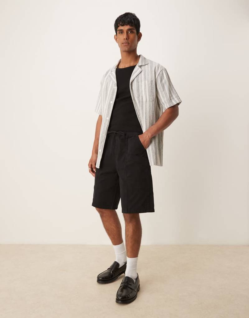 ASOS DESIGN - Längere Cargo-Shorts in Schwarz mit elastischem Bund von ASOS DESIGN