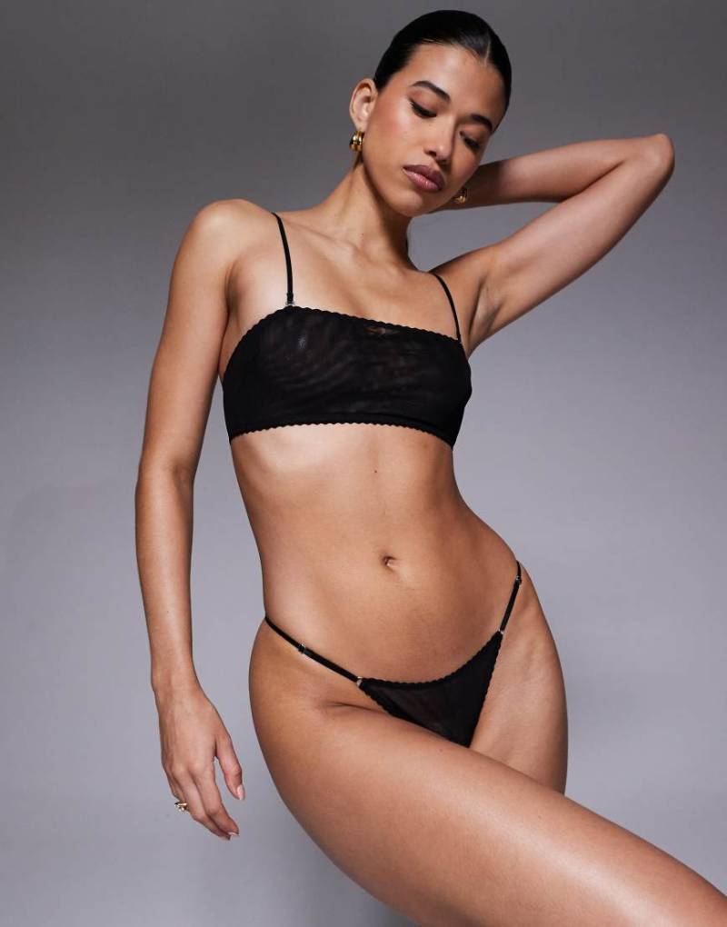ASOS DESIGN - Mila - Tanga aus Netzstoff in Schwarz mit verstellbaren Seiten von ASOS DESIGN