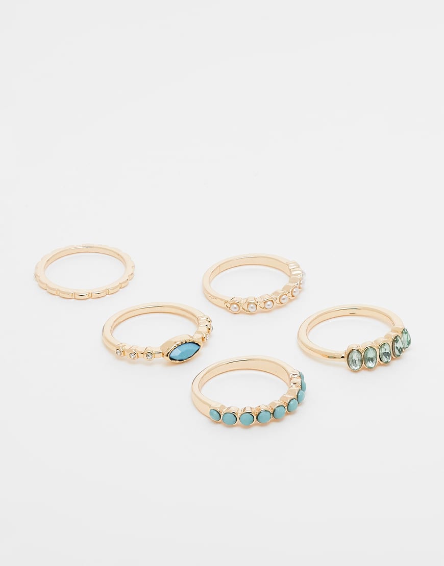 ASOS DESIGN - Multipack goldfarbener Ringe in verschiedenen Designs, mit blauen Schmucksteinen und Zierperlen von ASOS DESIGN