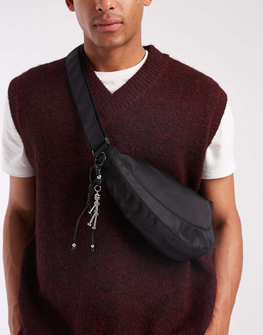 ASOS DESIGN - Nylon-Umhängetasche in Schwarz mit Anhänger von ASOS DESIGN
