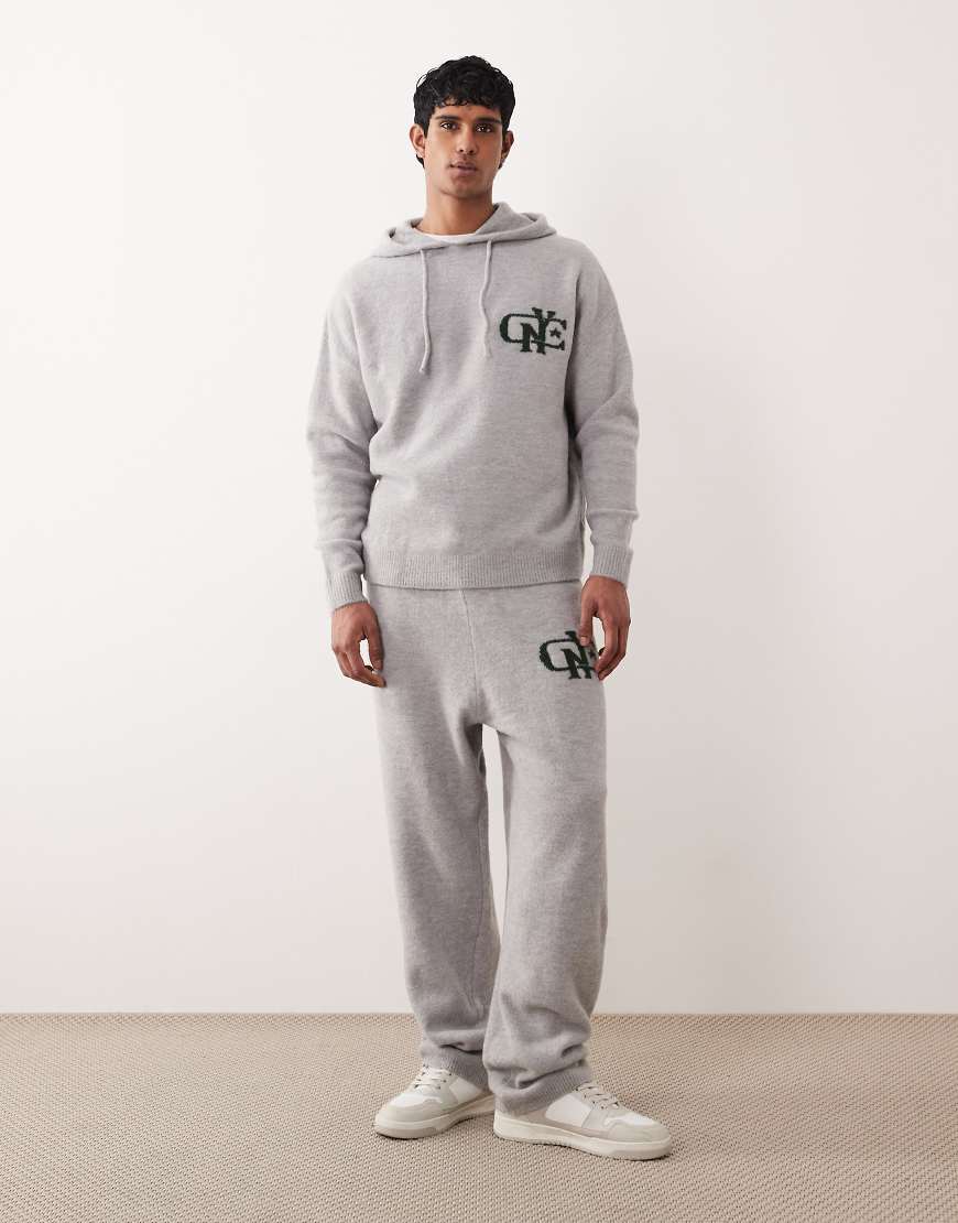 ASOS DESIGN - Oversize-Jogginghose aus Strickmaterial in verwaschenem Grau mit Bündchen und NYC-Logo auf der Brust, Kombiteil von ASOS DESIGN