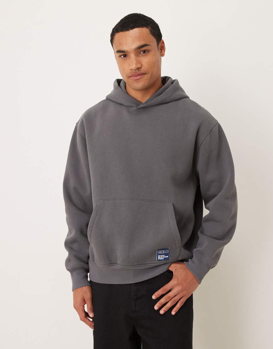 ASOS DESIGN - Oversize-Kapuzenpullover in anthrazitfarbener Acid-Waschung mit Logoaufnäher aus Webstoff-Grau von ASOS DESIGN