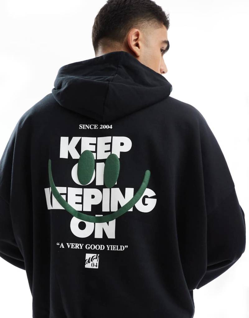ASOS DESIGN - Oversize-Kapuzenpullover mit Aufdruck hinten in Schwarz von ASOS DESIGN