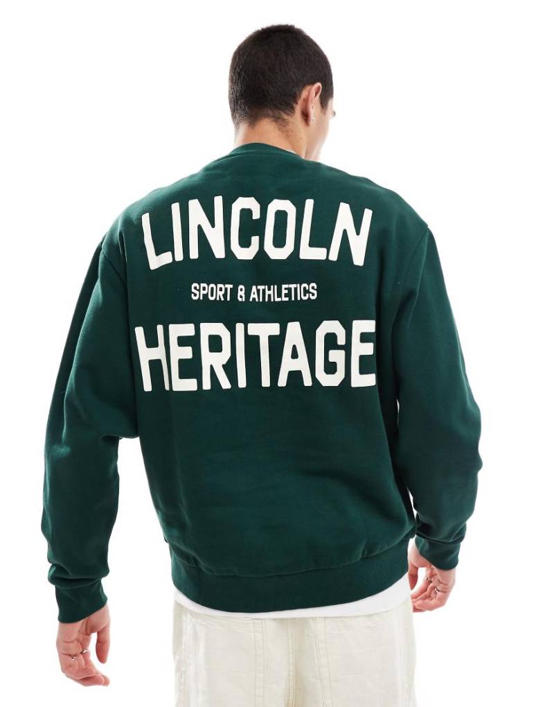 ASOS DESIGN - Sweatshirt in Dunkelgrün mit City-Print im College-Stil von ASOS DESIGN