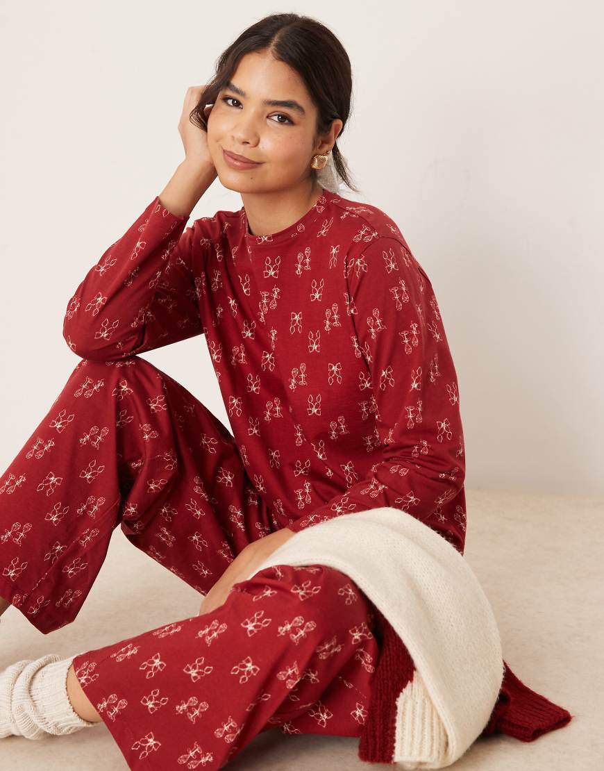 ASOS DESIGN - Pyjama-Set in Rot mit Schleifenmuster, aus Oberteil und Hose von ASOS DESIGN