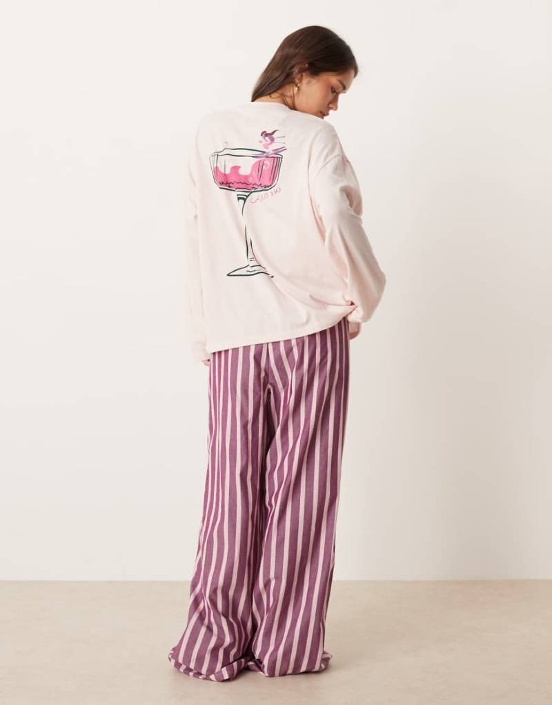 ASOS DESIGN - Pyjama aus langärmligem Shirt mit übergroßem Cocktail-Print und rosa gestreifter Hose mit weitem Bein von ASOS DESIGN