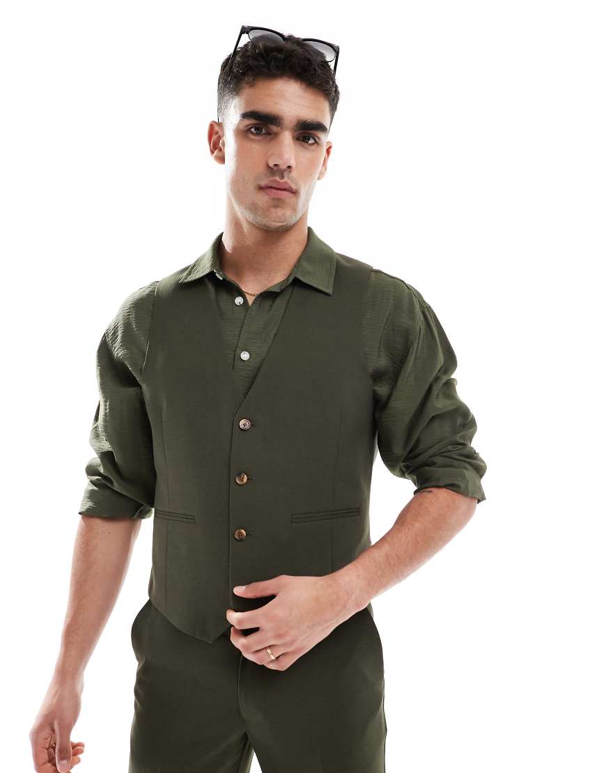 ASOS DESIGN - Schmal geschnittene Anzugweste in Olivgrün ASOS DESIGN - Schmal geschnittene Anzugweste in Olivgrün von ASOS DESIGN