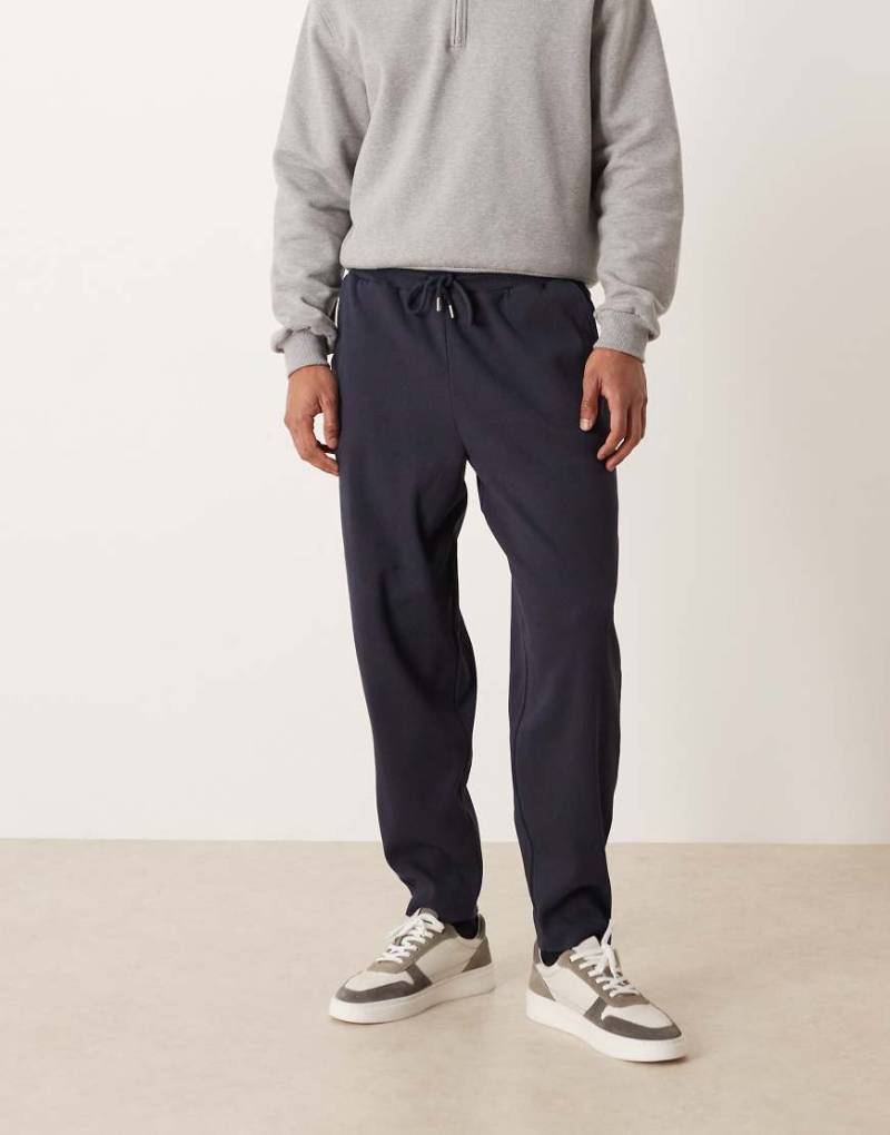 ASOS DESIGN - Schmal zulaufende, gerippte Jogginghose aus schwerem Stoff in Marineblau, Kombiteil von ASOS DESIGN