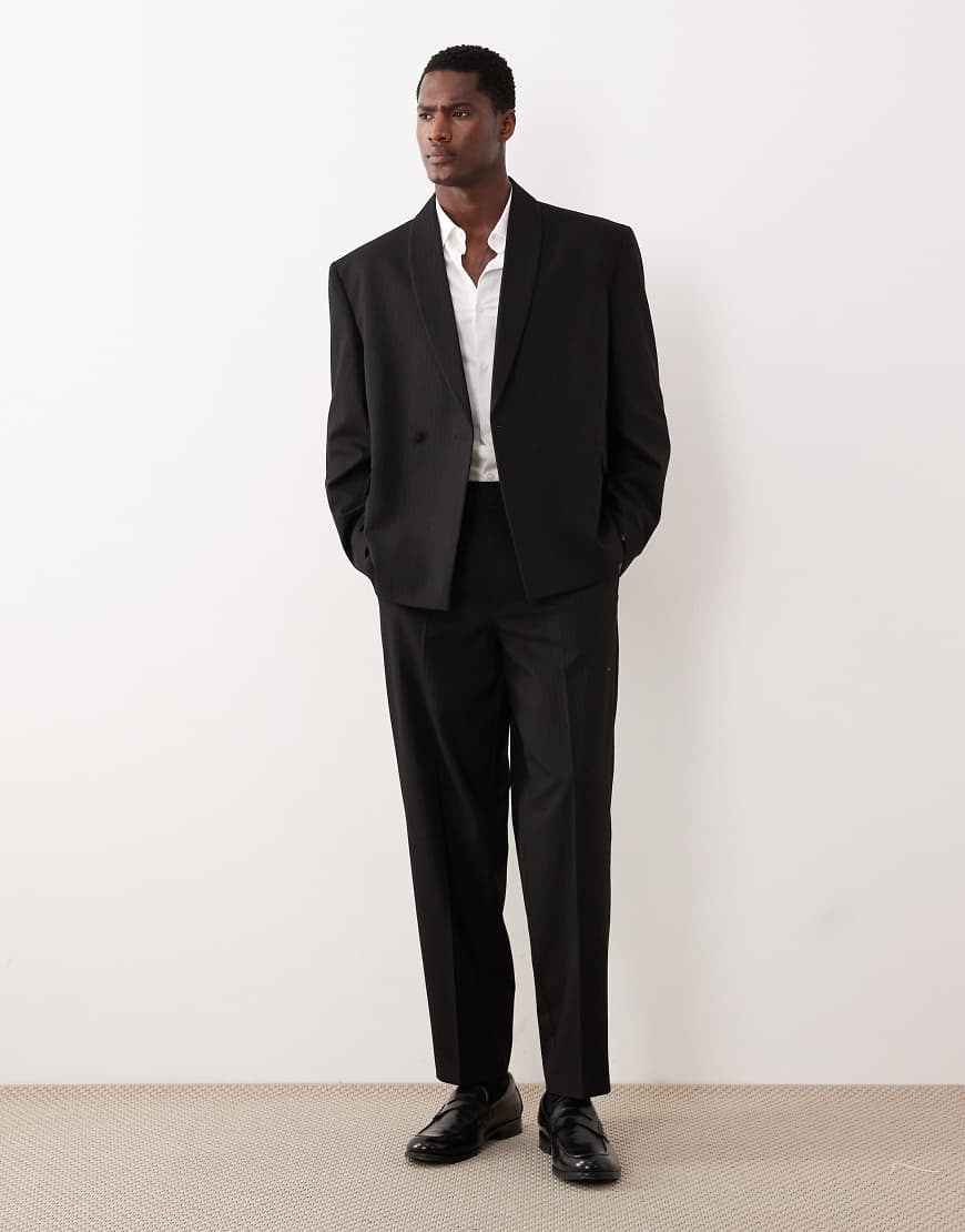 ASOS DESIGN - Schmal zulaufende Oversize-Anzughose in Schwarz mit farblich abgestimmten Metallic-Streifen von ASOS DESIGN
