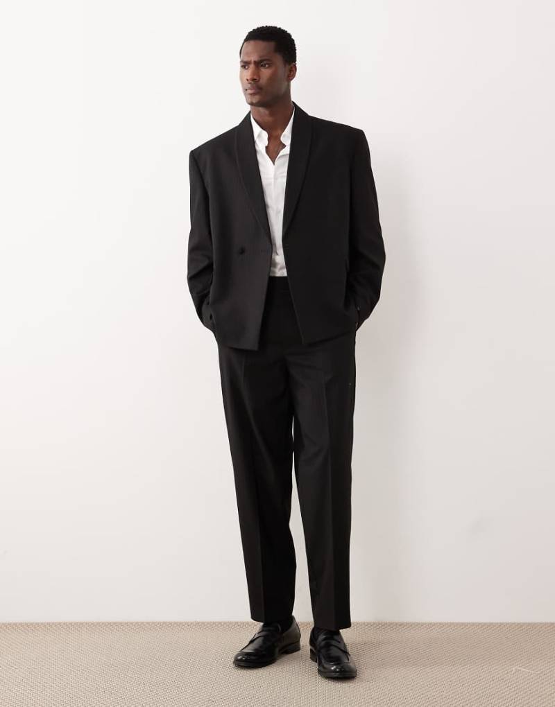 ASOS DESIGN - Schmal zulaufende Oversize-Anzughose in Schwarz mit farblich abgestimmten Metallic-Streifen von ASOS DESIGN