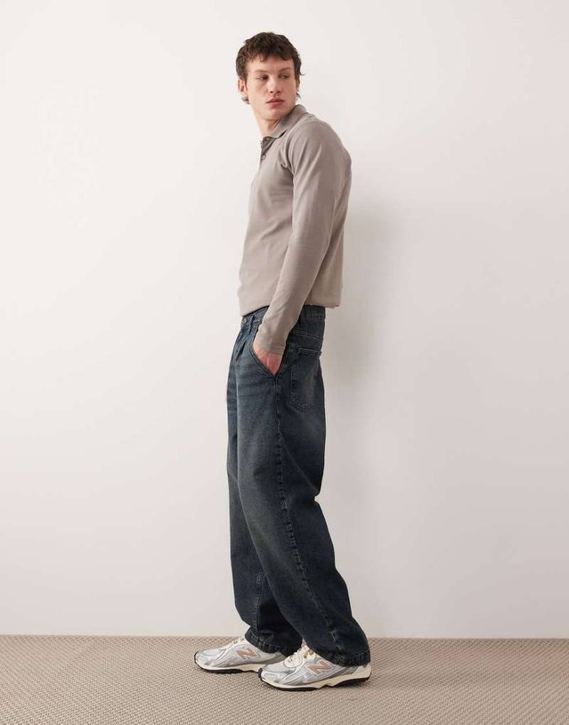 ASOS DESIGN - Schmal zulaufende Relaxed-Fit-Jeans in dunkelblauer Waschung von ASOS DESIGN