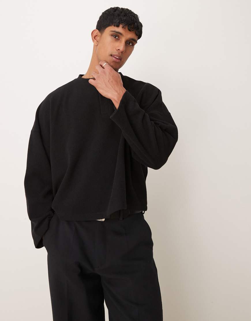 ASOS DESIGN - Schwerer, gerippter Henley-Pullover in Schwarz mit kurzem Super-Oversize-Schnitt ASOS DESIGN - Schwerer, gerippter Henley-Pullover in Schwarz mit kurzem Super-Oversize-Schnitt von ASOS DESIGN