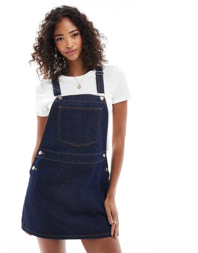 ASOS DESIGN - Sehr kurzes Jeans-Latzkleid in Bleach-Waschung-Blau von ASOS DESIGN