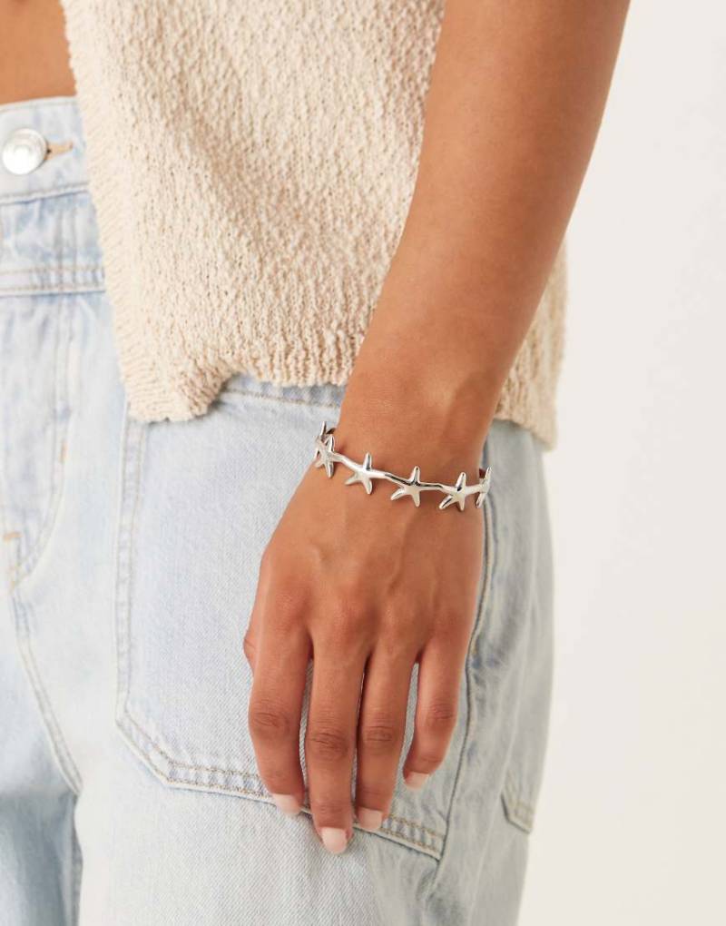 ASOS DESIGN - Silberfarbener Armreif aus wasserfestem Edelstahl mit kleinen Seesterndetails von ASOS DESIGN