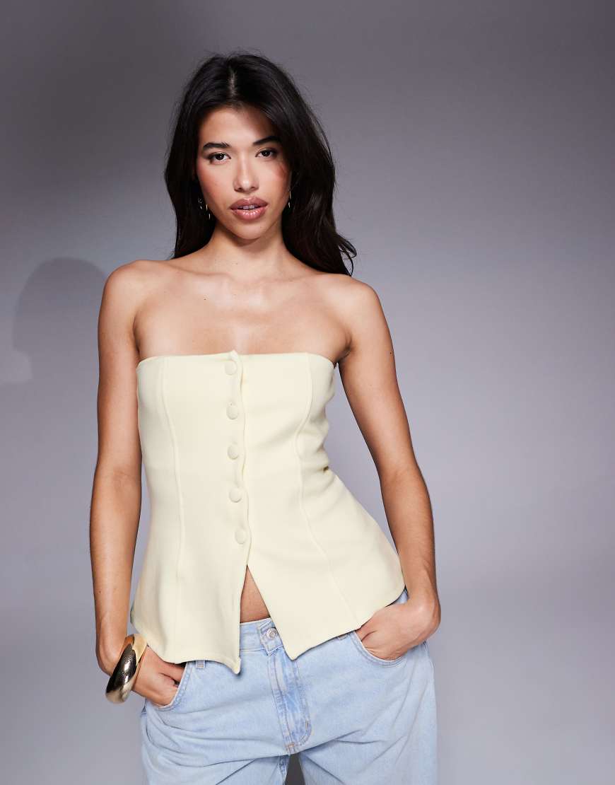 ASOS DESIGN - Strukturiertes, geknöpftes Korsett-Top aus Ponte in Buttermilchgelb ASOS DESIGN - Strukturiertes, geknöpftes Korsett-Top aus Ponte in Buttermilchgelb von ASOS DESIGN
