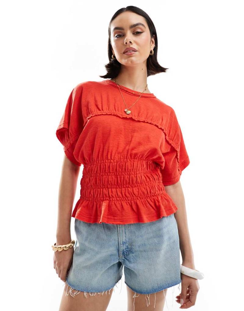 ASOS DESIGN - Strukturiertes, genopptes T-Shirt in Rot mit gesmokter Taille von ASOS DESIGN