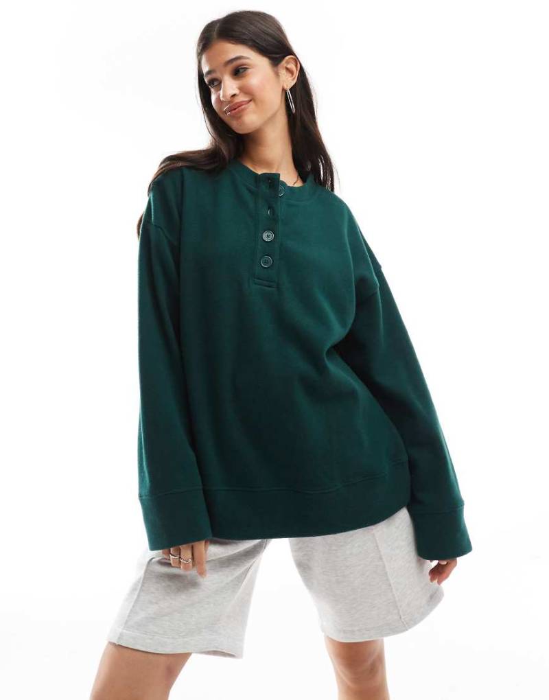 ASOS DESIGN - Superweicher Oversize-Pullover in Dunkelgrün mit Henley-Ausschnitt von ASOS DESIGN