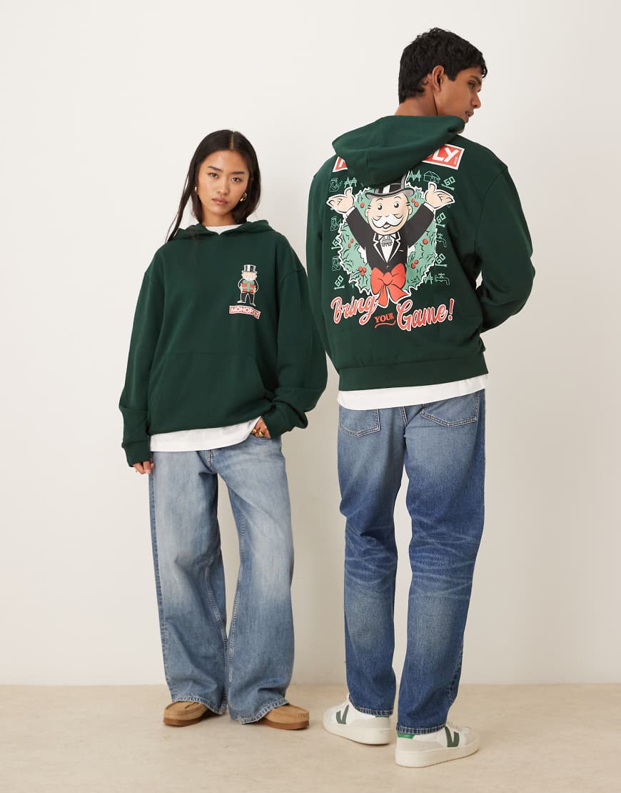 ASOS DESIGN - Unisex-Kapuzenpullover in Grün mit „Monopoly Christmas"-Print und Oversize-Schnitt von ASOS DESIGN